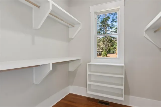 a view of walk in closet with empty racks