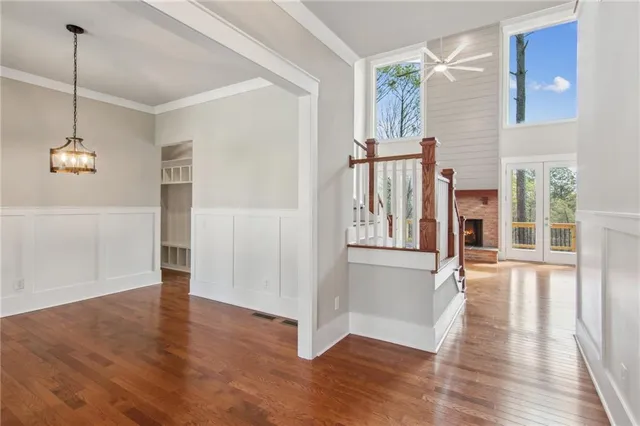 a view of a hallway with wooden floor and entryway