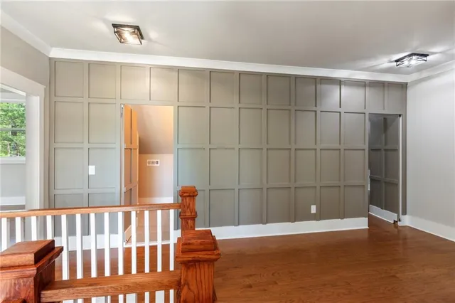 a view of a room with wooden floor