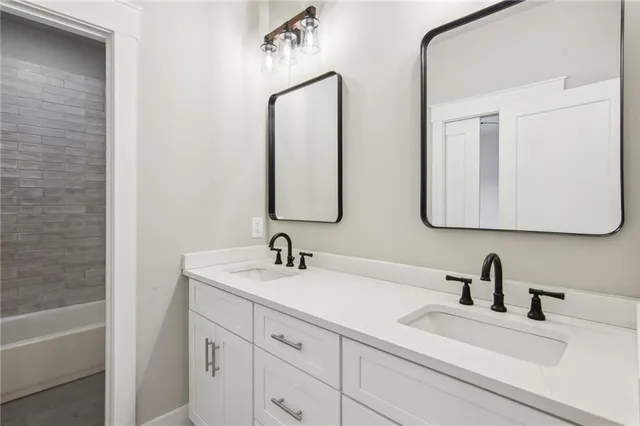a bathroom with a double vanity sink and a mirror