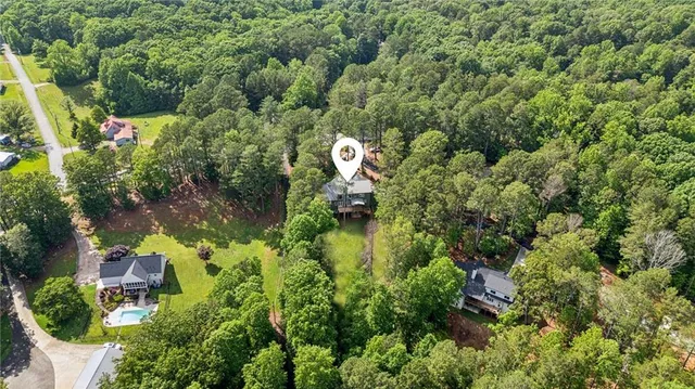 an aerial view of a house with a yard basket ball court and outdoor seating