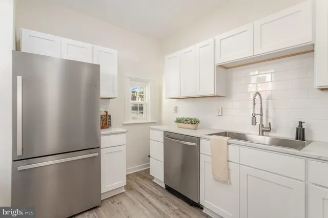 a white refrigerator freezer sitting in a kitchen