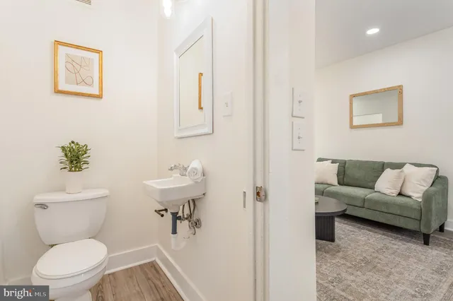 a bathroom with a toilet sink and a mirror