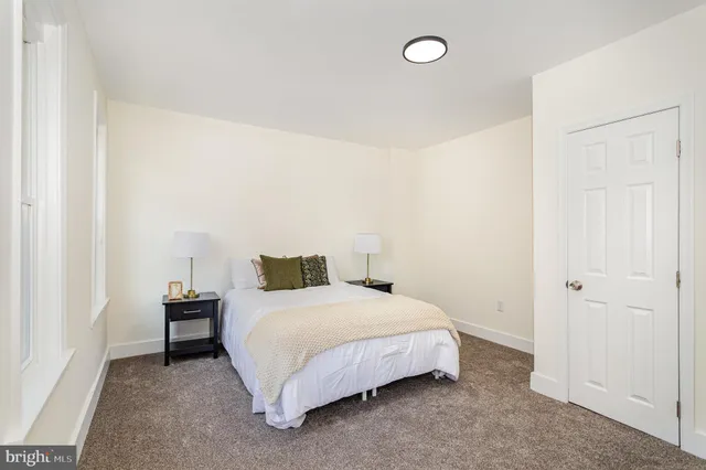 a bedroom with a bed and a table