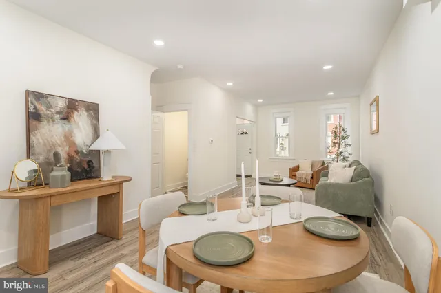 a living room with furniture and a dining table