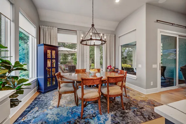 a kitchen with a stove a counter top space appliances and a living room