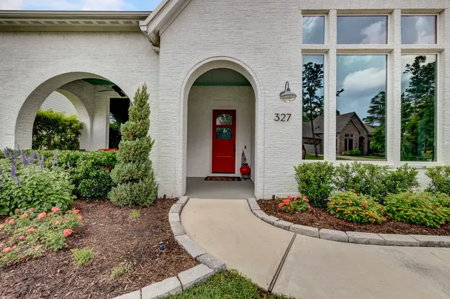a view of a brick house with potted plants