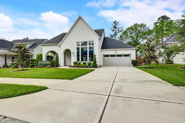 a view of a white house with a yard