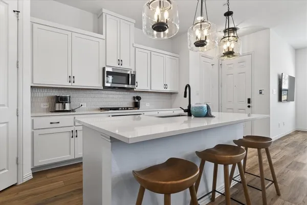 a kitchen with stainless steel appliances granite countertop a sink and cabinets