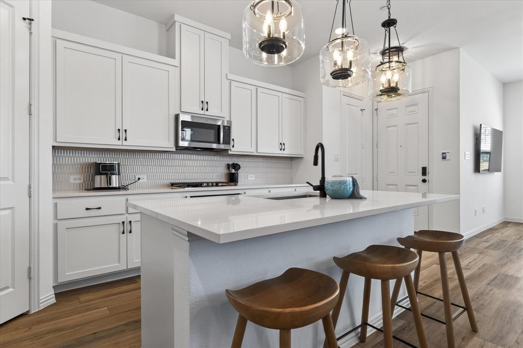 3038 Opera Way Sachse, TX 75048 - Photo 11 of 31 a kitchen with stainless steel appliances granite countertop a sink and cabinets