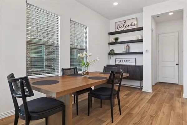 a view of a dining room with furniture and wooden floor