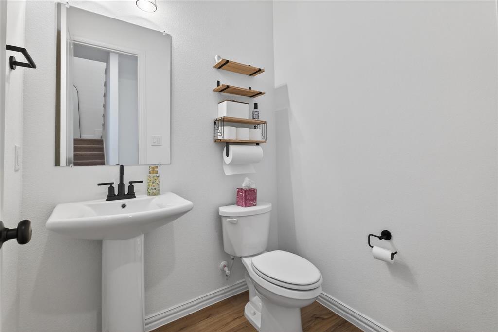 3038 Opera Way Sachse, TX 75048 - Photo 13 of 31 a bathroom with a sink toilet and a mirror