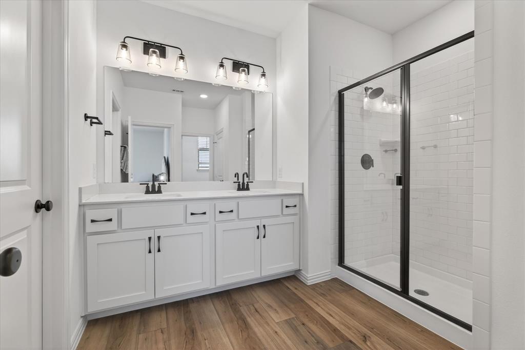 3038 Opera Way Sachse, TX 75048 - Photo 25 of 31 a spacious bathroom with a double vanity sink a mirror and shower