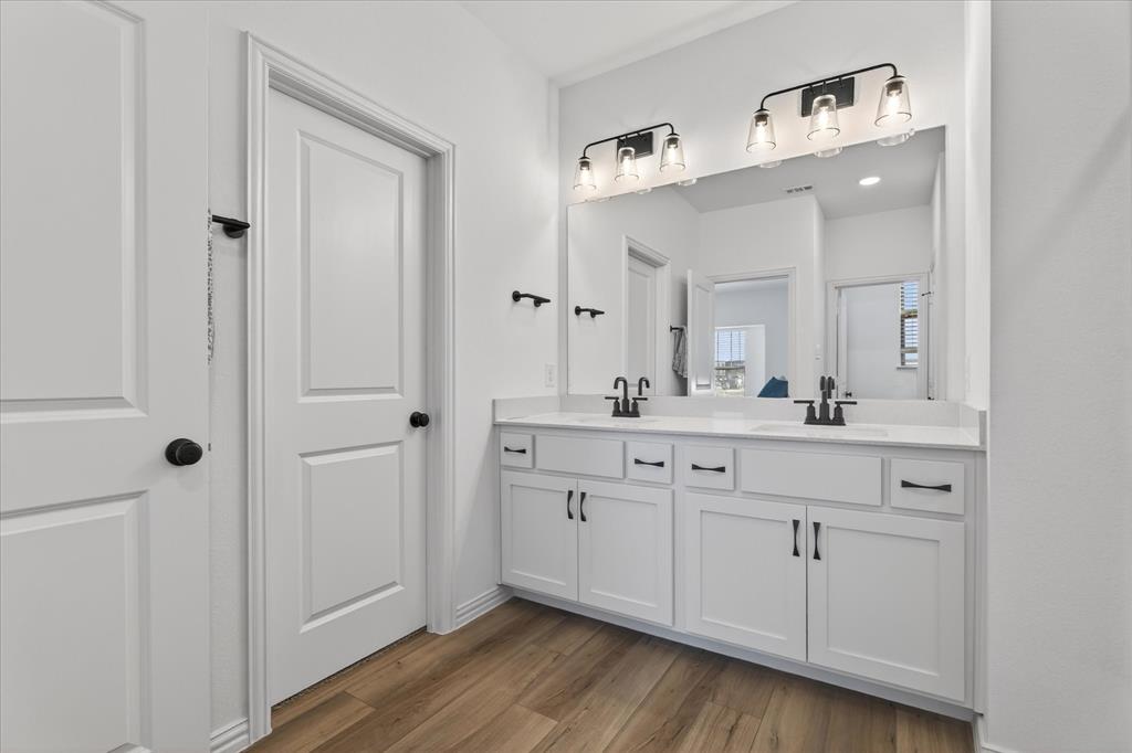3038 Opera Way Sachse, TX 75048 - Photo 27 of 31 a spacious bathroom with a double vanity sink and mirror