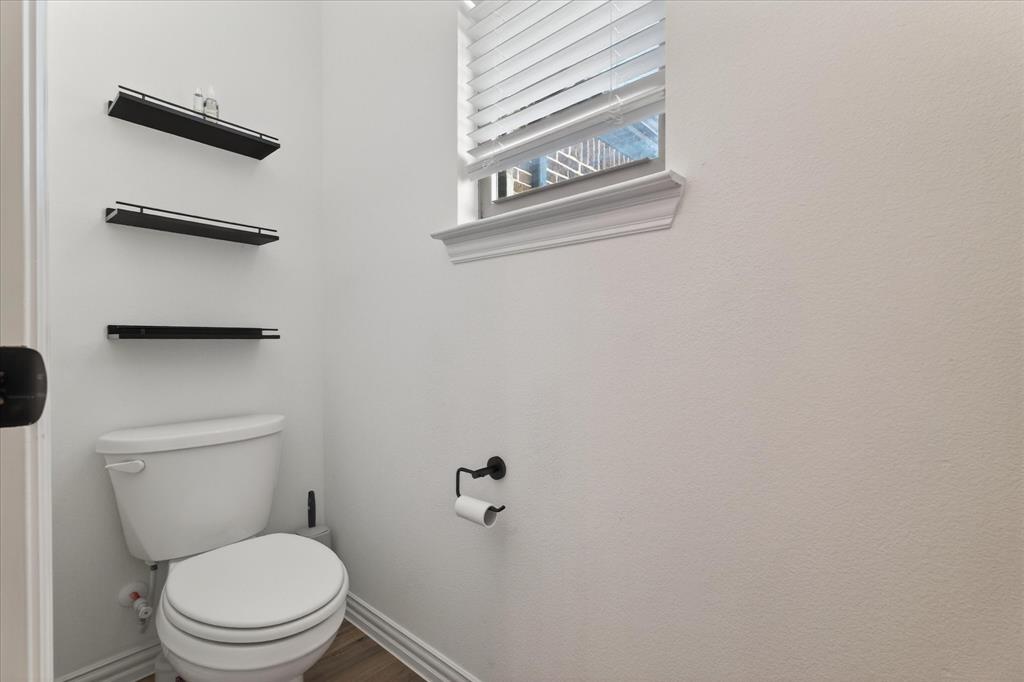 3038 Opera Way Sachse, TX 75048 - Photo 28 of 31 a white toilet sitting next to a shower