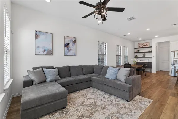 a living room with furniture and wooden floor