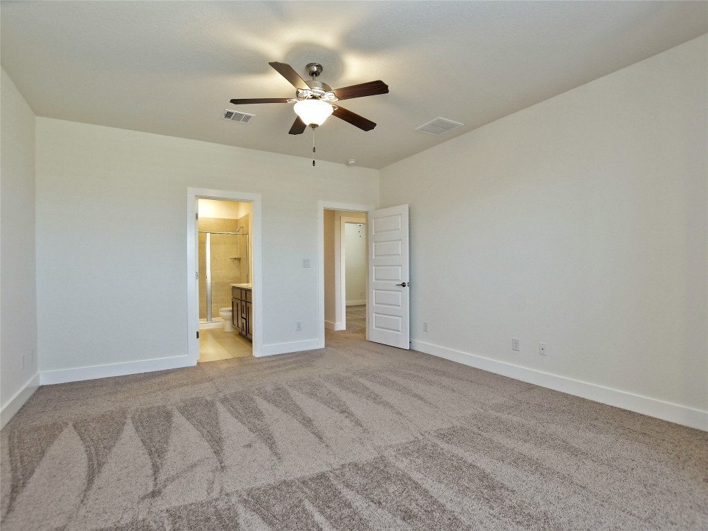 402 Parkline Drive, Unit 24A Georgetown, TX 78626 - Photo 17 of 27 a view of an empty room with a chandelier fan