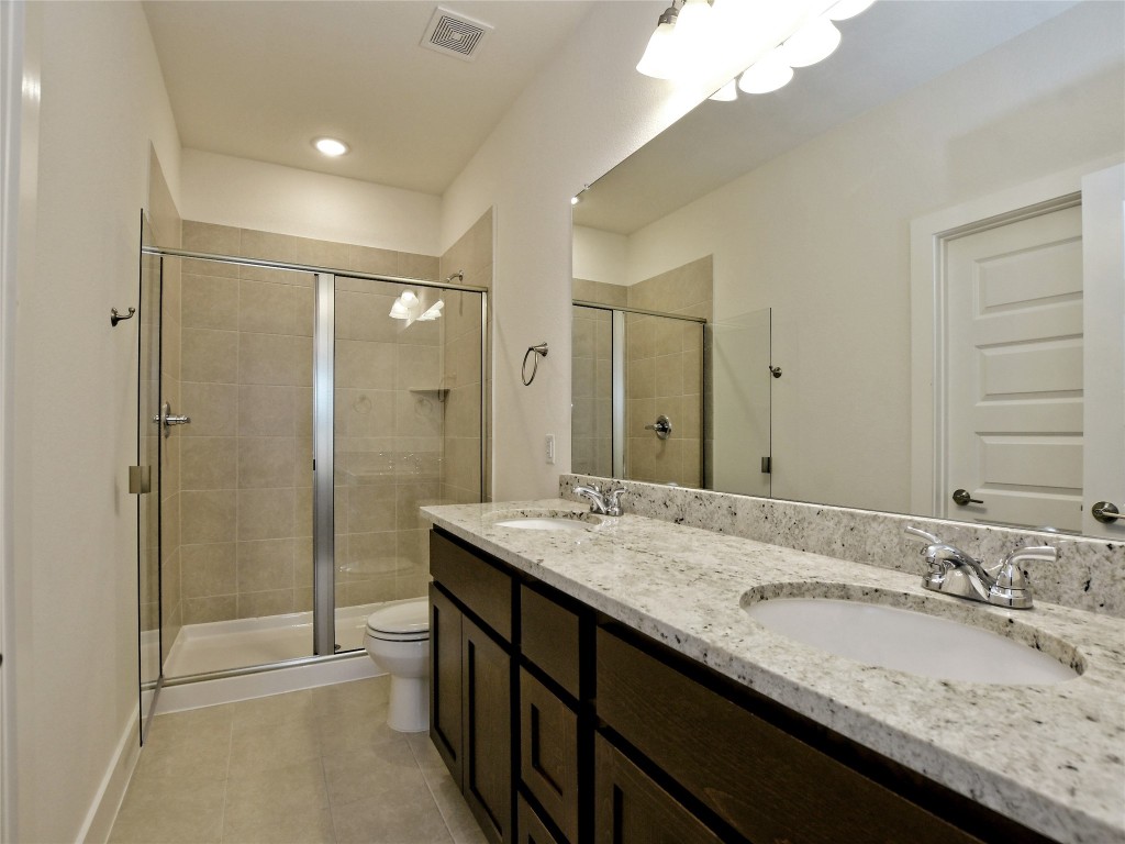 402 Parkline Drive, Unit 24A Georgetown, TX 78626 - Photo 20 of 27 a bathroom with a granite countertop sink a mirror a shower and a bathtub