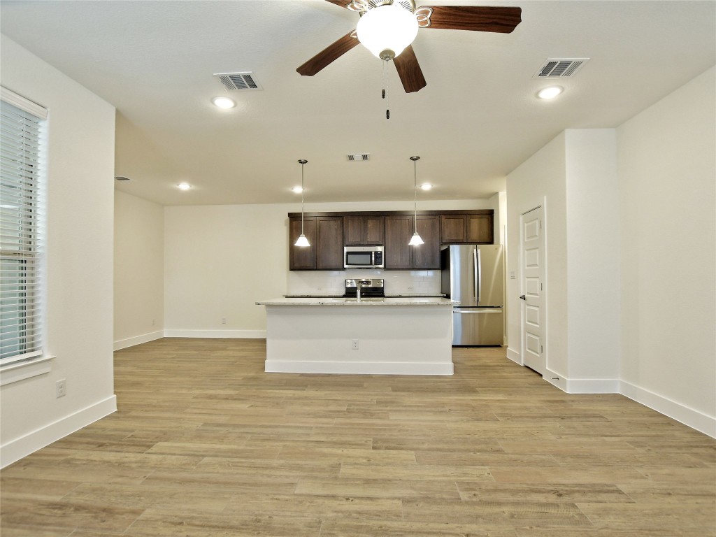 402 Parkline Drive, Unit 24A Georgetown, TX 78626 - Photo 8 of 27 a view of kitchen with refrigerator microwave and stove