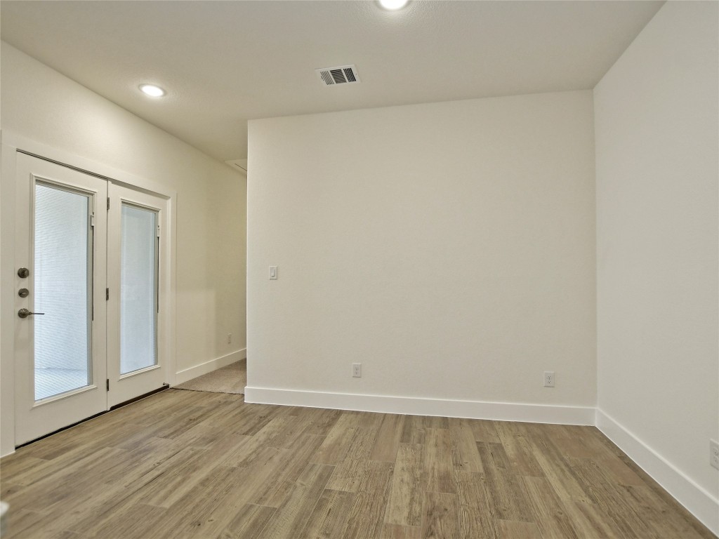 402 Parkline Drive, Unit 24A Georgetown, TX 78626 - Photo 9 of 27 a view of an empty room with wooden floor