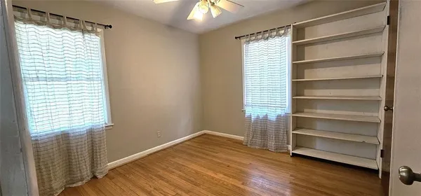 a view of walk in closet with empty racks