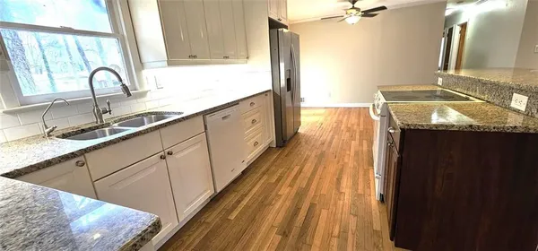 a kitchen with sink and mirror