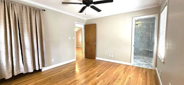 a view of a livingroom with wooden floor and door