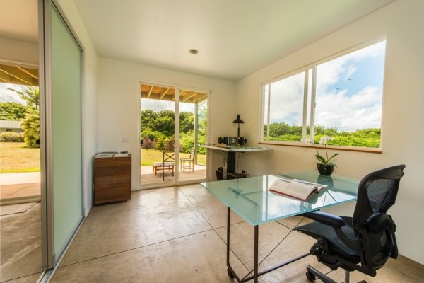 7561 Koolau Road, Unit B Kilauea, HI 96754 - Photo 14 of 25 a living room with furniture and a floor to ceiling window