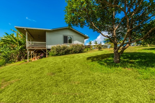 7561 Koolau Road, Unit B Kilauea, HI 96754 - Photo 18 of 25 a front view of house with yard and green space