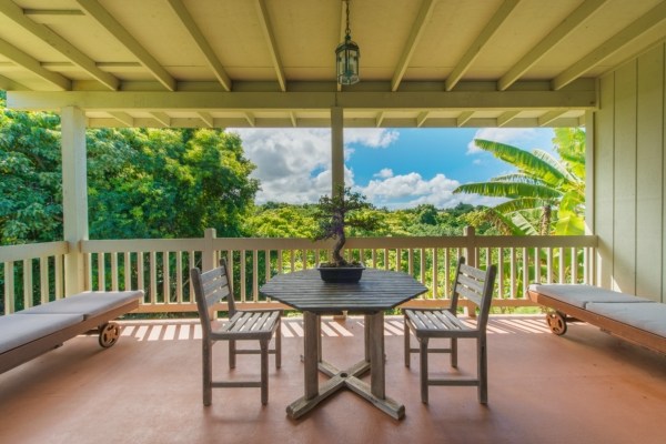 7561 Koolau Road, Unit B Kilauea, HI 96754 - Photo 19 of 25 a view of a patio with a table chairs and a ocean view