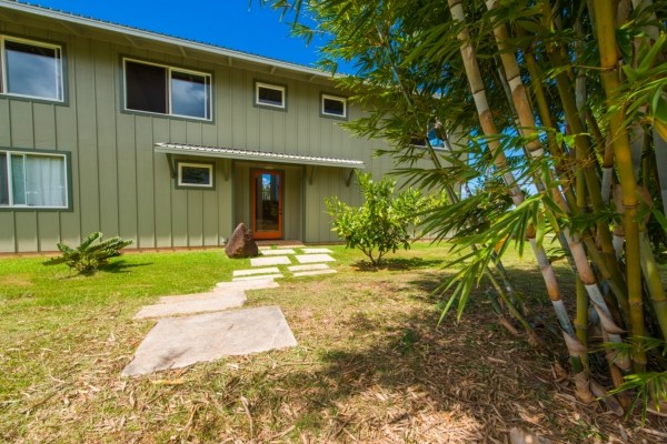 7561 Koolau Road, Unit B Kilauea, HI 96754 - Photo 3 of 25 a front view of a house with garden
