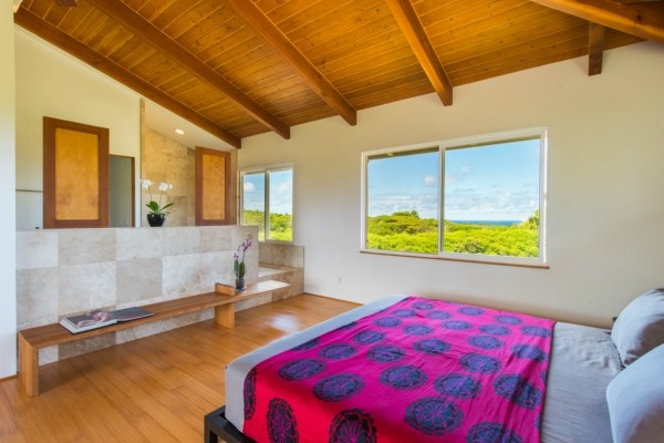7561 Koolau Road, Unit B Kilauea, HI 96754 - Photo 5 of 25 a bed sitting in a bedroom next to a window