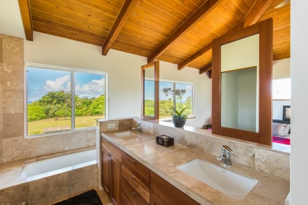 7561 Koolau Road, Unit B Kilauea, HI 96754 - Photo 7 of 25 a bathroom with a granite countertop sink and a large mirror
