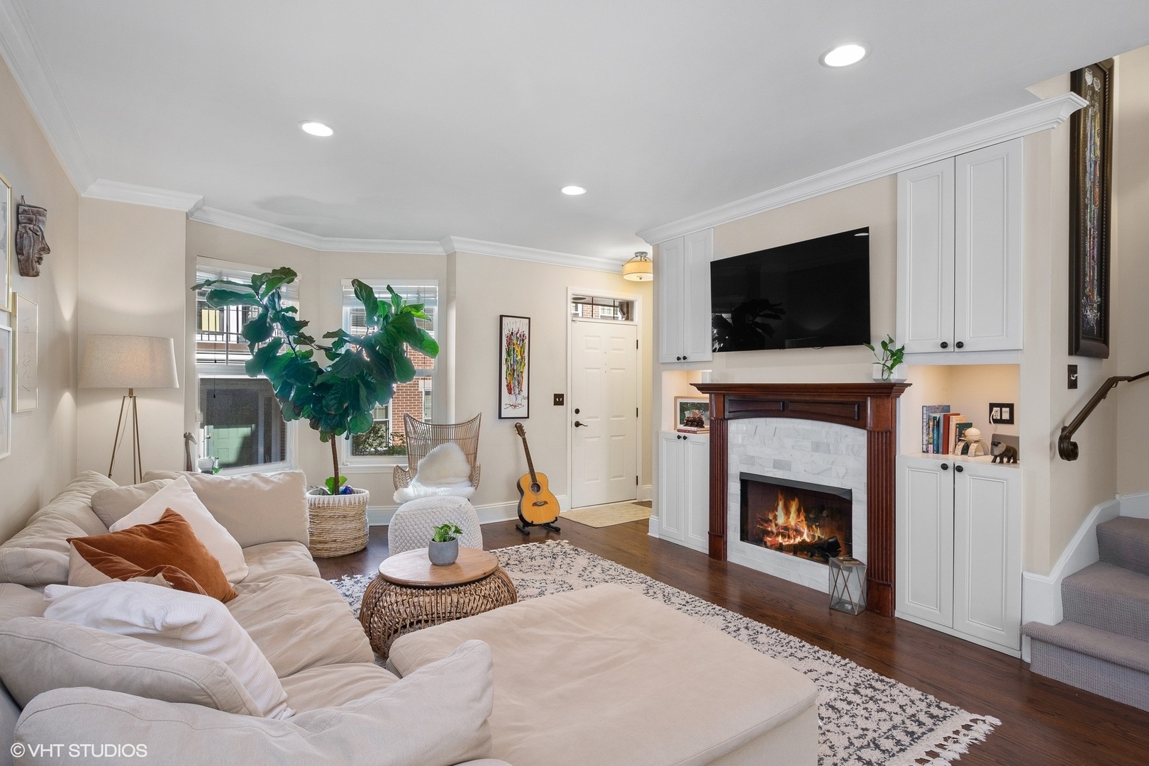 220 West Scott Street, Unit F Chicago, IL 60610 - Photo 2 of 19 a living room with furniture a flat screen tv and a fireplace