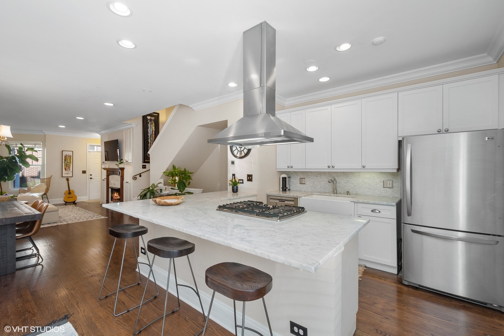220 West Scott Street, Unit F Chicago, IL 60610 - Photo 5 of 19 a kitchen with stainless steel appliances granite countertop a sink a stove a refrigerator and chairs