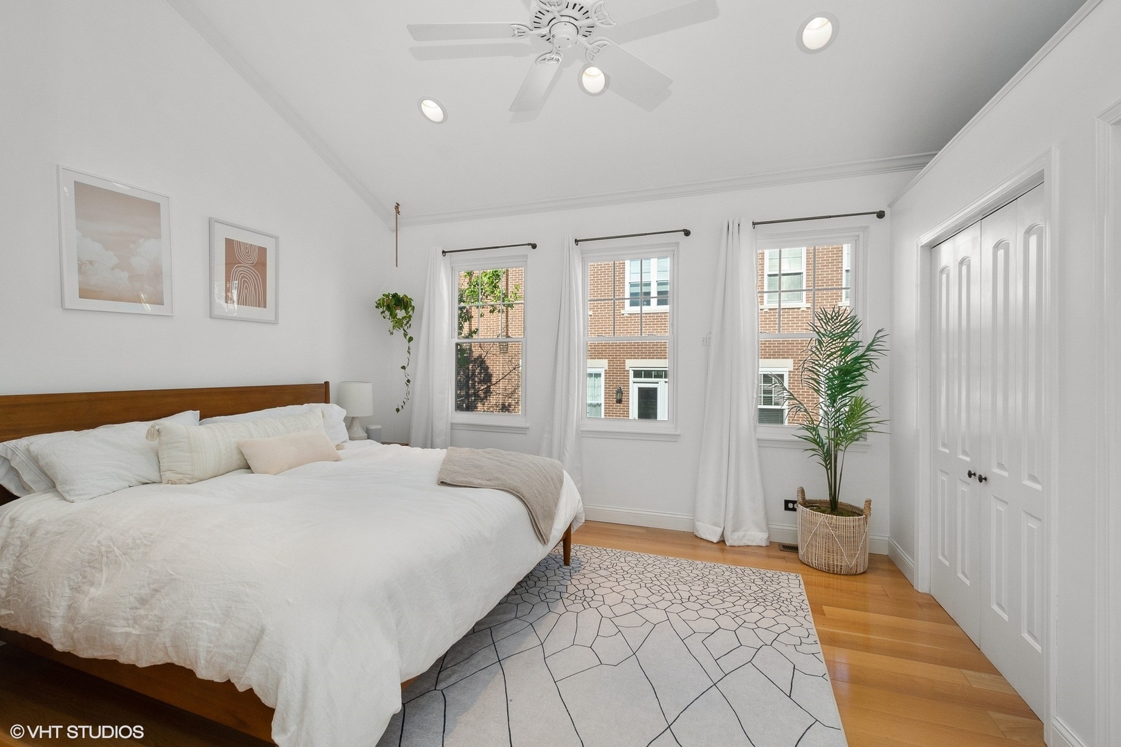 220 West Scott Street, Unit F Chicago, IL 60610 - Photo 7 of 19 a spacious bedroom with a large bed and a chandelier