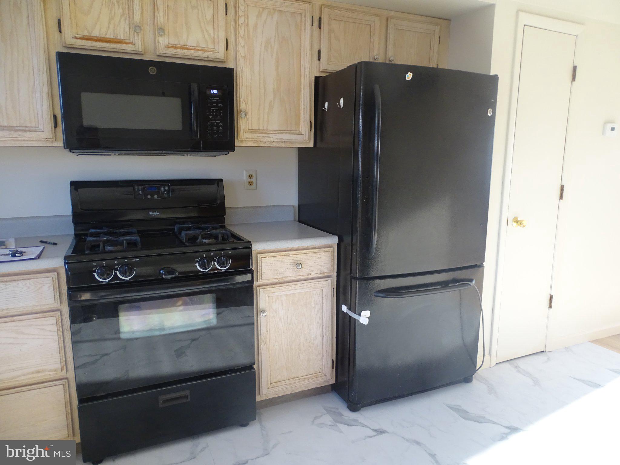 711 Hill Road, Unit D Wernersville, PA 19565 - Photo 12 of 13 a kitchen with a refrigerator stove and microwave