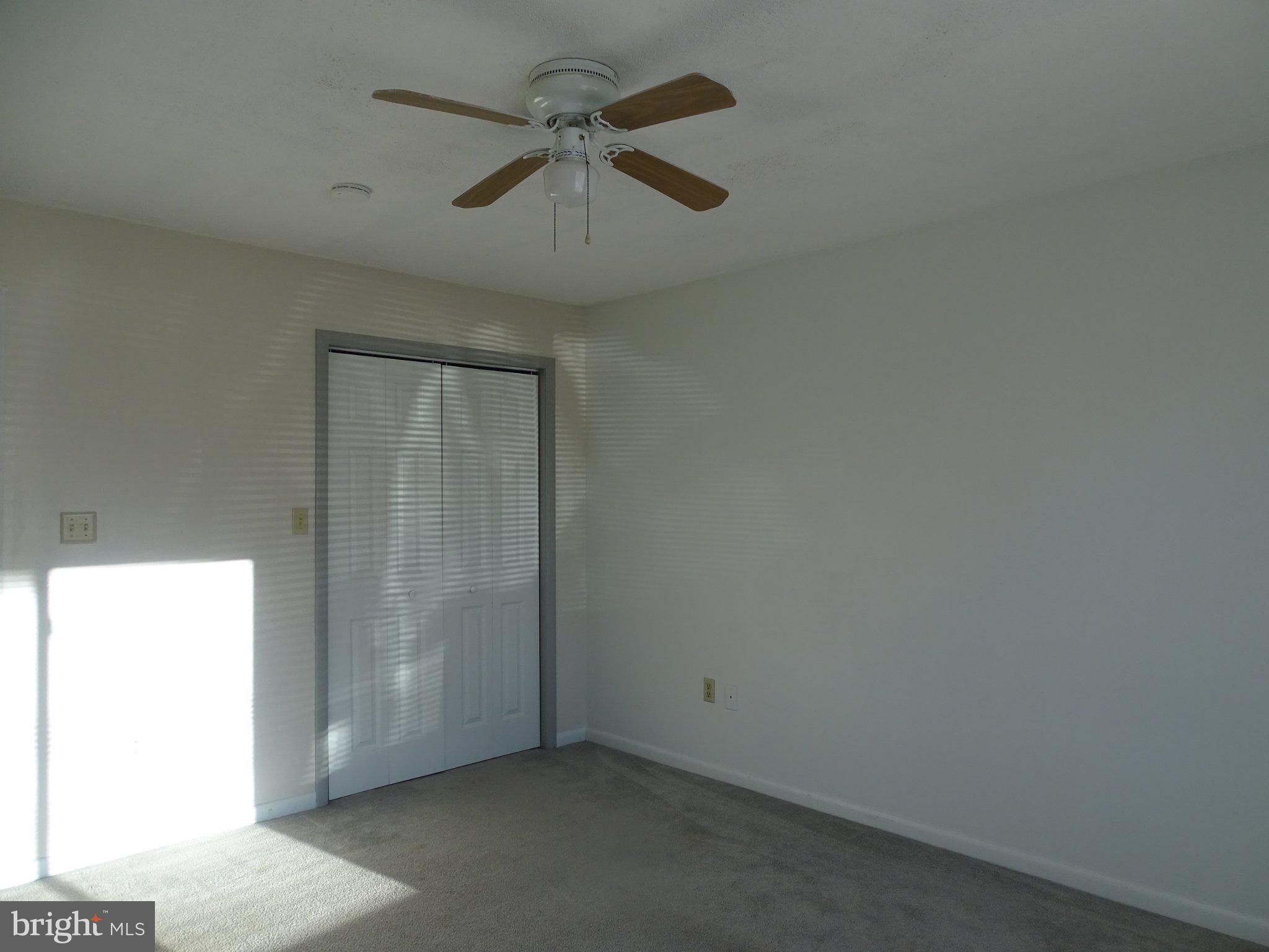 711 Hill Road, Unit D Wernersville, PA 19565 - Photo 6 of 13 an empty room with a ceiling fan and a window