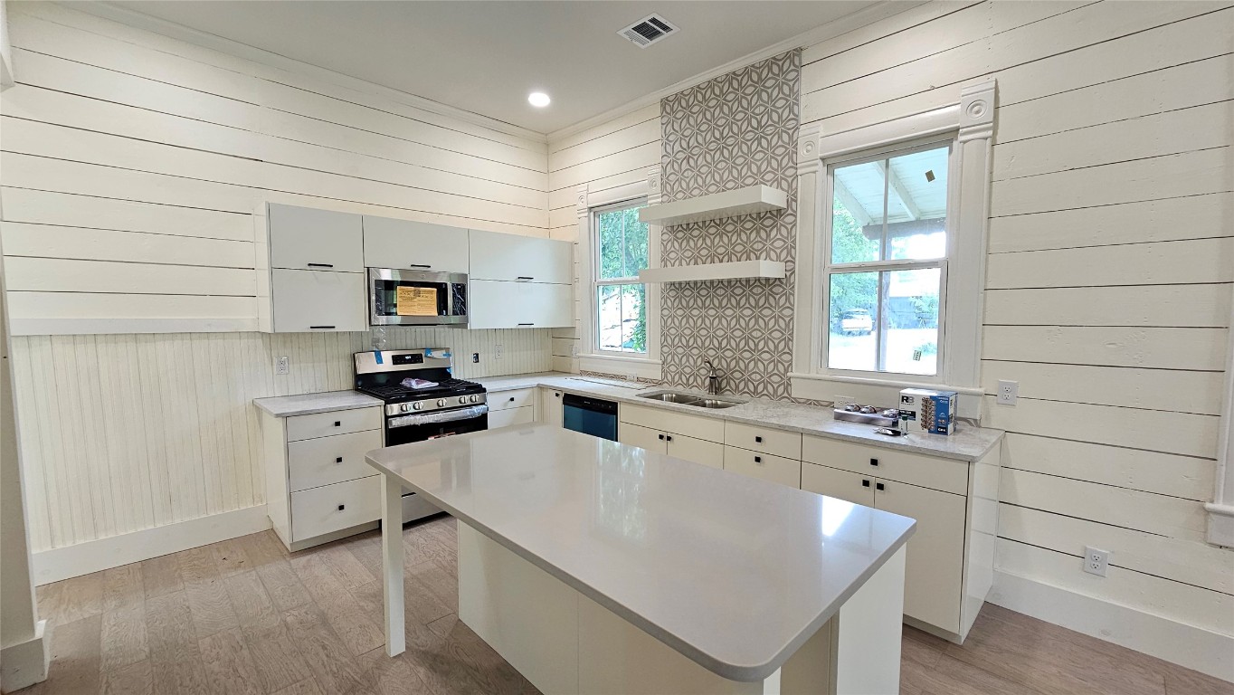 a kitchen with a sink stove and refrigerator