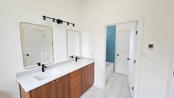 a bathroom with a double vanity sink and mirror