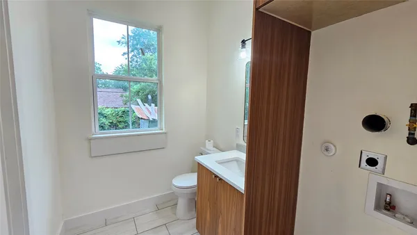 a bathroom with a granite countertop sink a toilet and shower