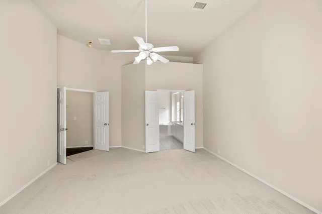 a view of a room with a ceiling fan and a window