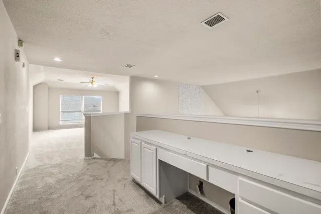 a view of storage and utility room with empty racks