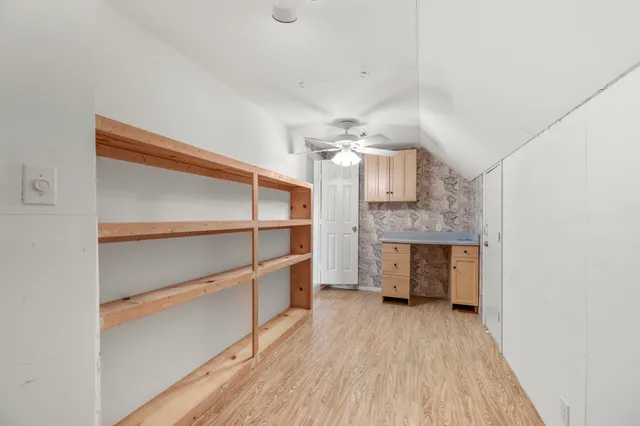 a view of a room with wooden floor and staircase