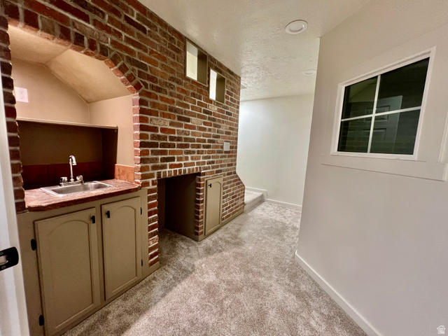 812 East Bates Cyn Road Tooele, UT 84074 - Photo 73 of 144 Built-in wet bar with a stainless steel sink, countertop, and lower cabinetry