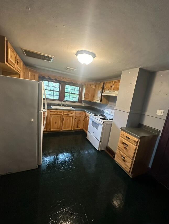 1815 Riverdale Road Southeast Roanoke, VA 24014 - Photo 7 of 10 a kitchen with stainless steel appliances a stove a sink and a refrigerator