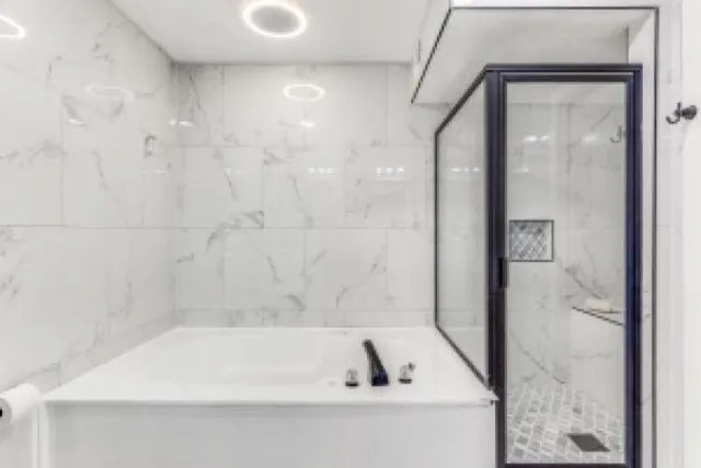 a bathroom with a bathtub and a shower