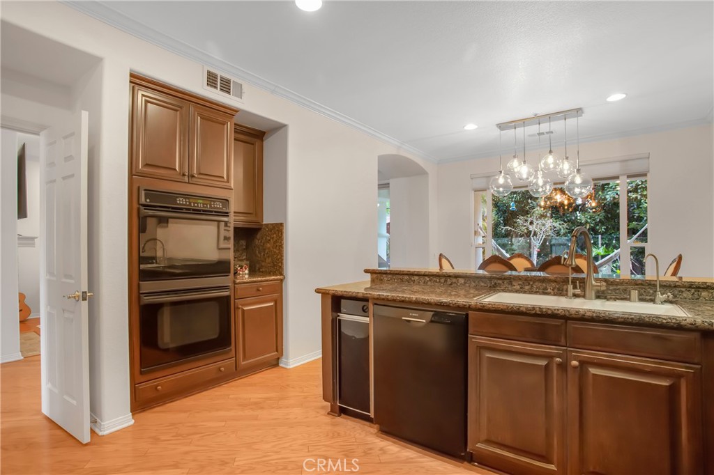 3 Avenida Cristal San Clemente, CA 92673 - Photo 12 of 36 a kitchen with kitchen island granite countertop a sink stainless steel appliances and cabinets