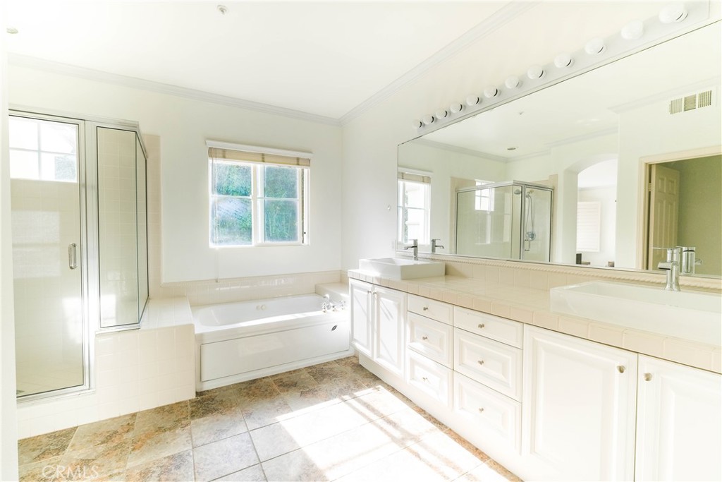 3 Avenida Cristal San Clemente, CA 92673 - Photo 19 of 36 a spacious bathroom with a granite countertop tub sink a mirror a shower and vanity