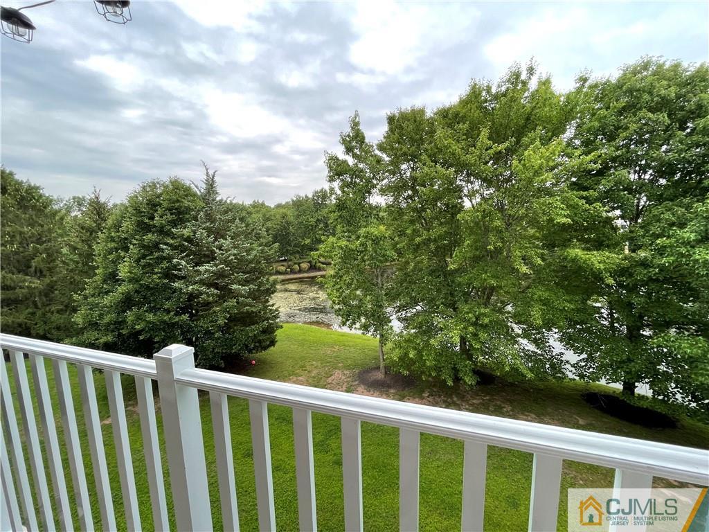 341 Wimbeldon Court North Brunswick, NJ 08902 - Photo 16 of 16 a balcony with trees in front of it